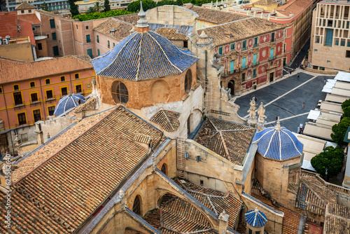 View from above of the architectural details and the cathedral of Santa Maria de Murcia, Spain with its characteristic blue tiles and the Plaza del Cardenal Belluga in the background photo