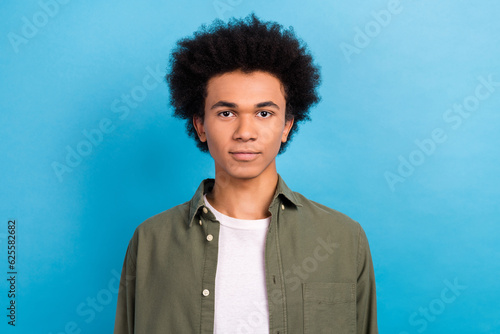 Portrait of young confident business owner man student wear stylish khaki shirt funny chevelure hairstyle isolated on blue color background