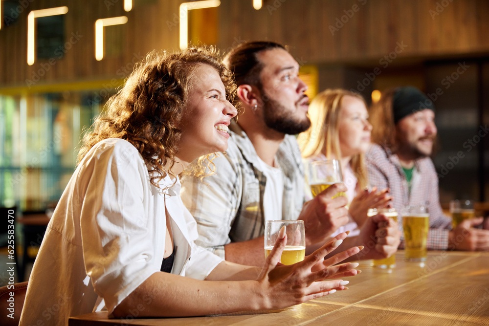 Sport fans, friends sitting at pub, bar, watching online football match translation, drinking beer, cheering up team. Concept of sport competition, hobby, lifestyle, human emotions, fun