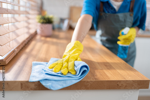 Close up hand cleaning home and wiping with microfiber cloth in kitchen room at home 