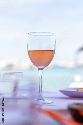 glass of red wine on seaside restaurant table
