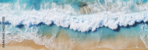 Drone perspective overlooking the clean and beautiful beach and waves