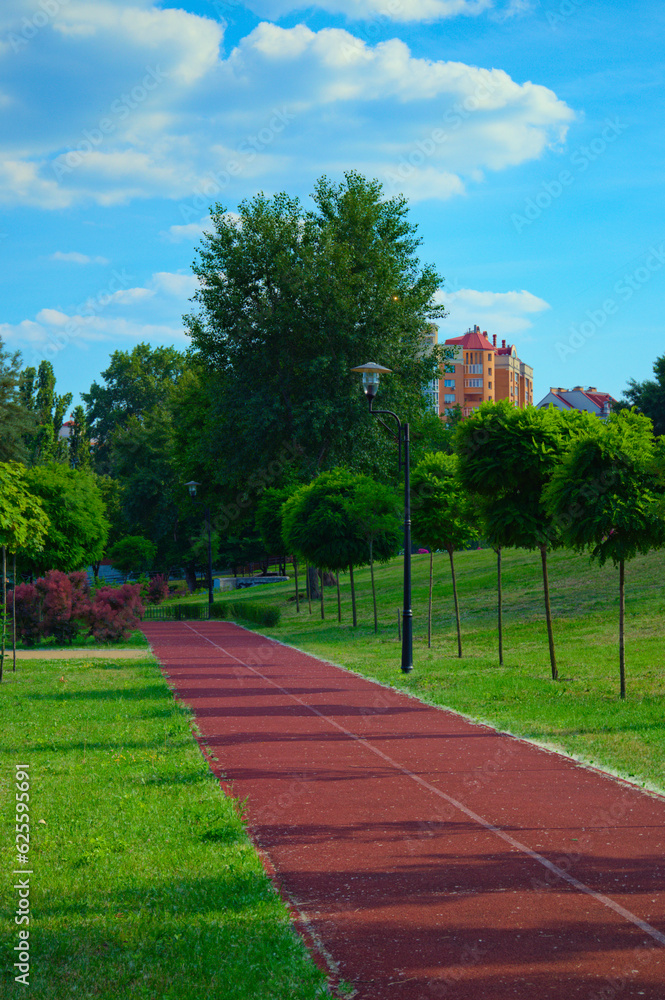 Empty running track in the city park. Rubber coating. Red treadmill in the Natalka park in Kyiv, Ukraine. Concept of healthy sport