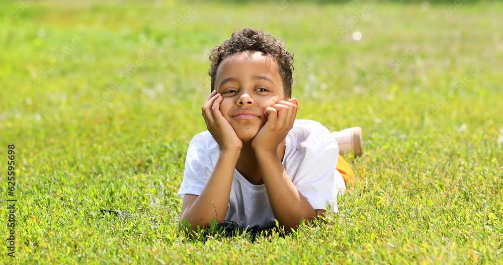 Funny moment - little boy pulling grass and smelling flowers Funny moment - little boy pulling grass and smelling flowers