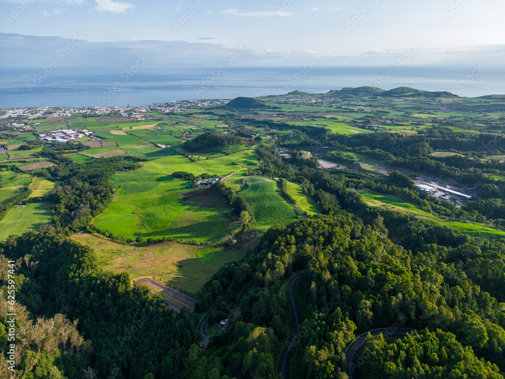 Traditional landscape in the Azores, lush green vegetation around. Aerial View. Sao Miguel, Azores, Portugal. 