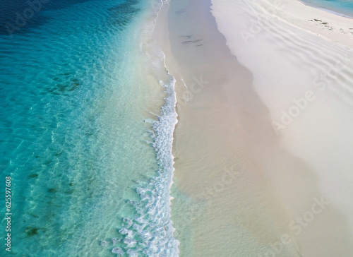 tropical white beach with waves and sea