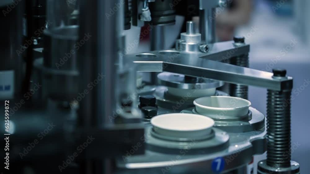 Automatic machine on paper cup production line. Modern technology and automation. Seamless loop. Automatic machine on paper cup production line. Modern technology and automation. Seamless loop.