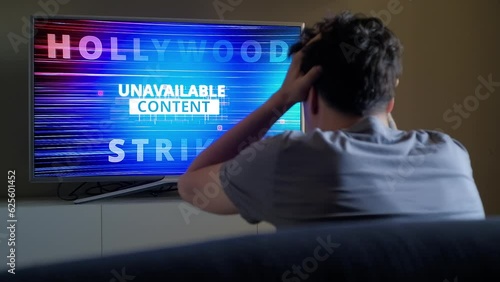 Upset viewer emotionally reacts on Hollywood Strike news on TV screen photo