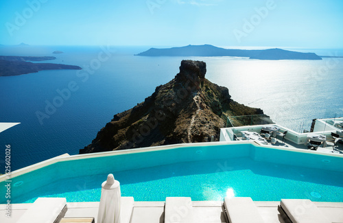 Santorini, Greece. Amazing view of blue sky, sea and Skaros rock from luxury resrot in Imerovigli in Santorini greek island. Location: Imerovigli  Santorini, Greece. photo