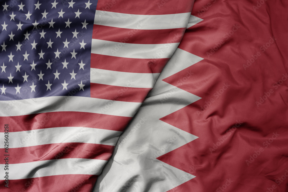 Obraz premium big waving colorful flag of united states of america and national flag of bahrain .