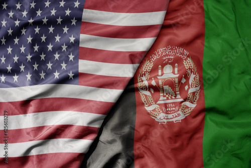 big waving colorful flag of united states of america and national flag of afghanistan .