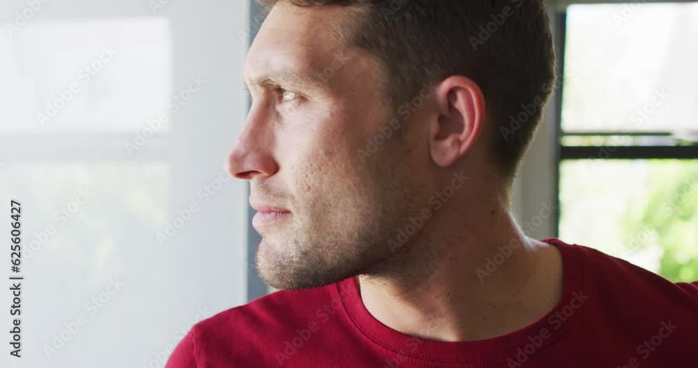 Thoughtful caucasian man is looking out the window Thoughtful caucasian man is looking out the window