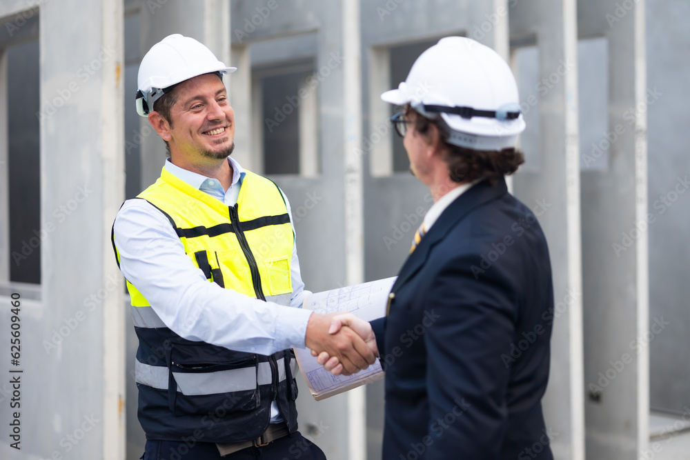 Business People shaking hands on business cooperation agreement. Successful hand shaking after good deal Heavy Industry Manufacturing Factory. Prefabricated concrete walls Business People shaking hands on business cooperation agreement. Successful hand shaking after good deal Heavy Industry Manufacturing Factory. Prefabricated concrete walls