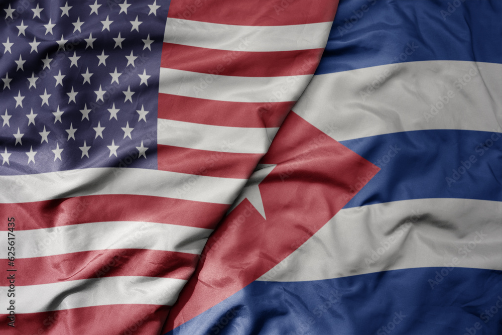 Obraz premium big waving colorful flag of united states of america and national flag of cuba .
