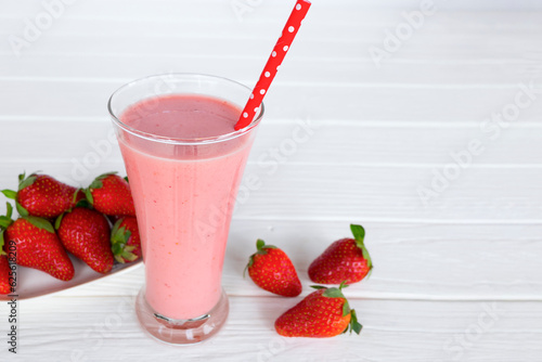 Strawberry yogurt fruit juice smoothie pink colorful fruit juice milkshake blend beverage healthy high protein the taste yummy In glass drink episode morning on white wood background.