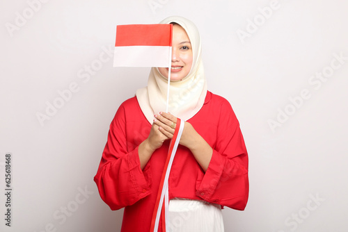 portrait of beautiful young asian woman with indonesian flag  of indonesia independence day on isolated white background photo