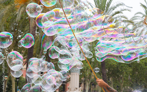 Soap bubbles floating and reflecting fantastic and surprising colours.