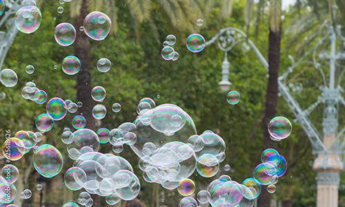 Soap bubbles floating and reflecting fantastic and surprising colours.