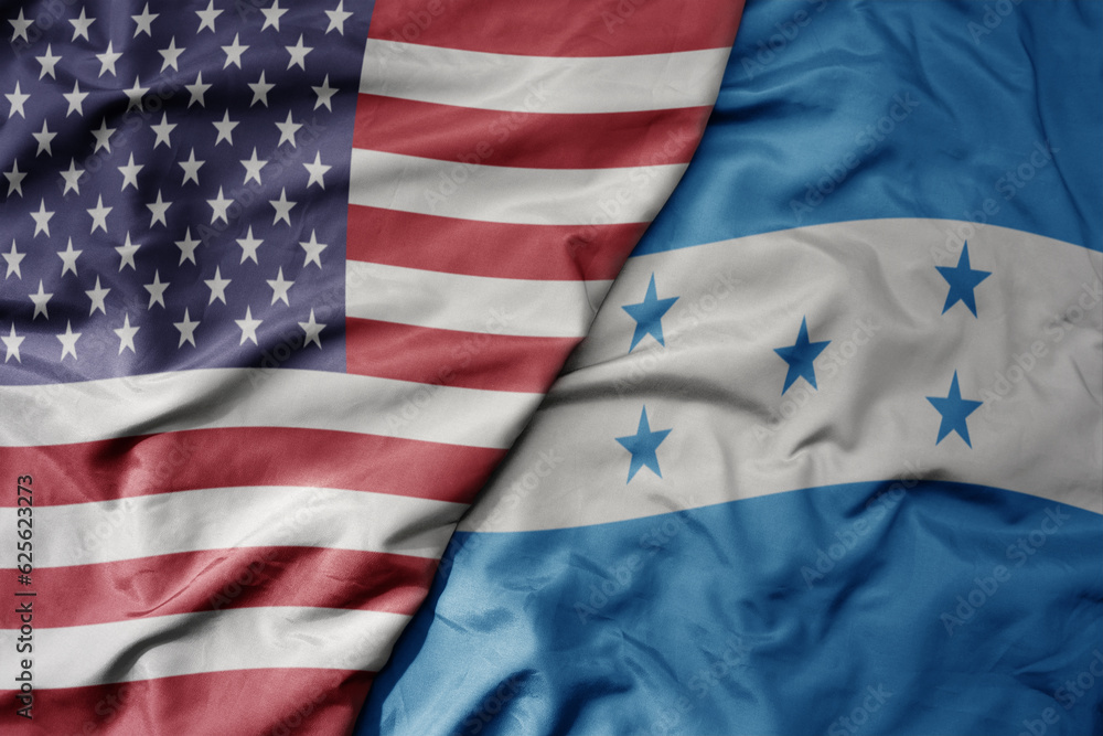Obraz premium big waving colorful flag of united states of america and national flag of honduras .