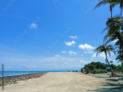 beach with palm trees © Bpchinamamun24