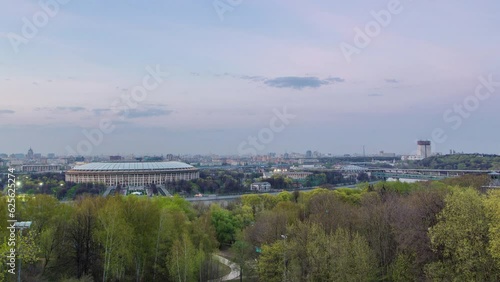 Panoramic view of Moscow City, Russia, from Sparrow Hills after sunset day to night transition timelapse. Luzhniki stadium and bridge over river