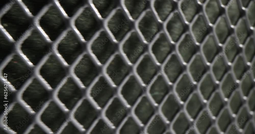 Grey perforated metal mesh as fence of private territory and housing. Concept of square grid pattern and texture as seamless design element Grey perforated metal mesh as fence of private territory and housing. Concept of square grid pattern and texture as seamless design element
