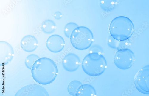 Beautiful Transparent Blue Soap Bubbles Floating in The Air. Abstract Blurred Background. Celebration Festive Backdrop. Soap Suds Bubbles Water 