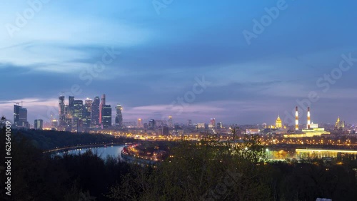 Panoramic view of Moscow City, Russia, from Sparrow Hills day to night transition timelapse from above. Cloudy colorful sky over skyscrapers