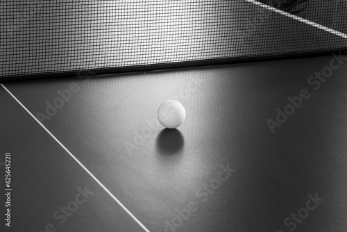 Tennis ball on the table. Black and white image.