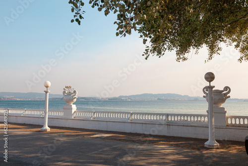 Island of La Toja, Ria de Aurosa, Galicia. Empty walkway and snow-white retro balustrade with beautiful vases of flowers.