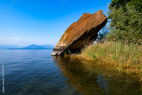 “Sasso Cavallazzo“ is a rock on the shore of “Lago Maggiore“ lake in northern Italy. Natural attraction and remain of ice age left by glaciers. Bathing spot and climbing attraction near Ranco Angera.