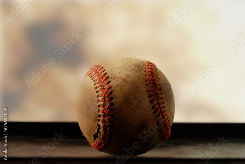 Seams on baseball closeup with blurred background for sports nostalgia style.