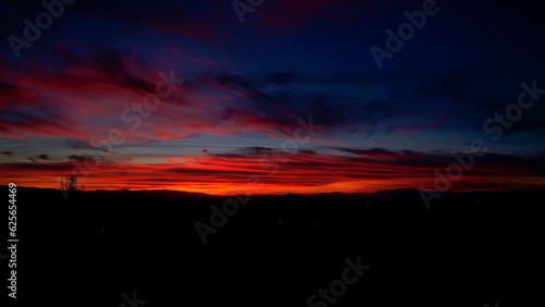 Colorful sunset at golden hour. Sky on fire at sunset with vivid colors from blue to red. Palette of natural colors at sunset. Granada. Andalusia. Spain. © Siroco Drones