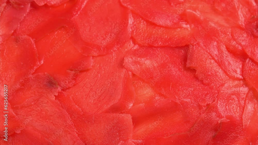 Red pickled ginger for sushi rolls rotates like background for restaurant, bars, public catering, screens. Colored Pickled Ginger for Japanese Cuisine Red pickled ginger for sushi rolls rotates like background for restaurant, bars, public catering, screens. Colored Pickled Ginger for Japanese Cuisine