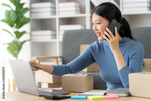 Quadro su tela Portrait of Starting small businesses SME owners female entrepreneurs working on receipt box and check online orders to prepare to pack the boxes, sell to customers, SME business ideas online