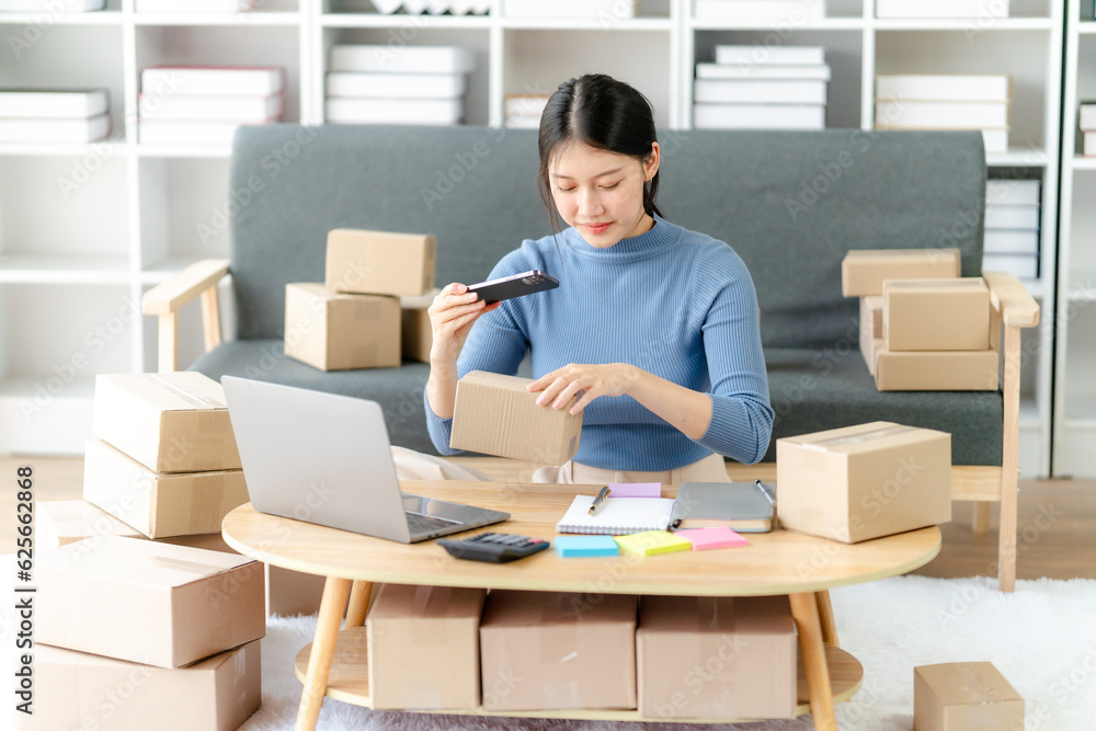 Young business owner woman prepare parcel box and standing check online orders for deliver to customer on tablet, laptop Shopping Online concept. Young business owner woman prepare parcel box and standing check online orders for deliver to customer on tablet, laptop Shopping Online concept.