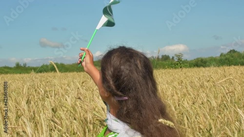 Girl waving flag of Pakistan outdoors . Happy independence day of Pakistan.