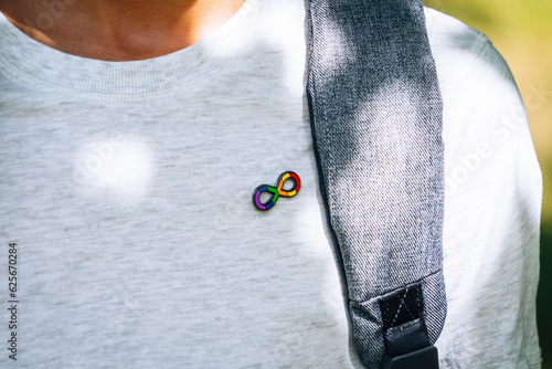 Obraz na plátne Adolescent boy with backpack with autism infinity rainbow symbol sign