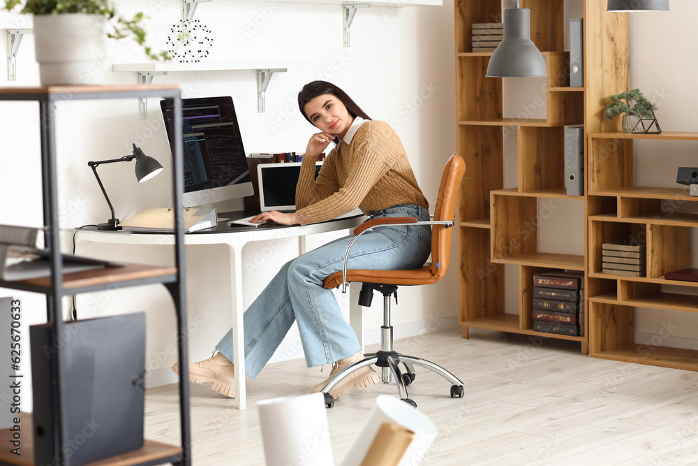 Young female programmer working in office Young female programmer working in office