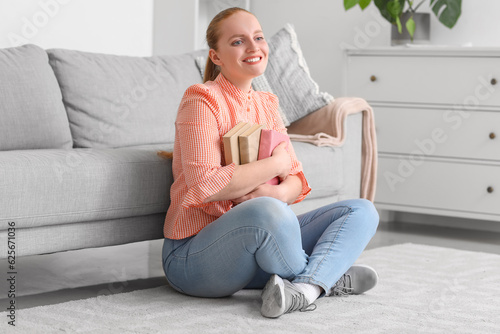Happy young woman with book...