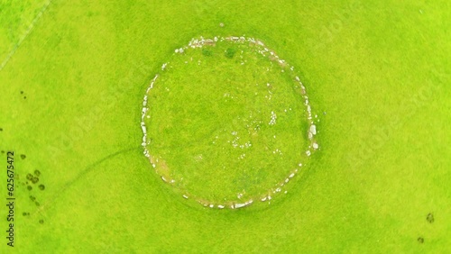 Aerial top-down view of female tourist exploring the famous Beltany stone circle photo