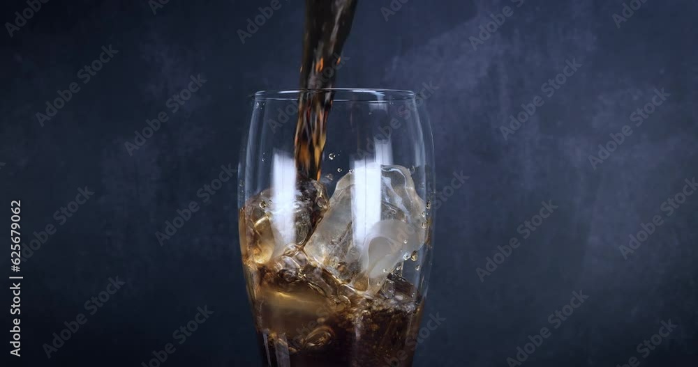 Cool glass of cola drink with ice, bubbles and fizz. Fresh cold sweet drink poured over ice cubes. Cola glass with summer refreshment on black. Slow motion 4k Cool glass of cola drink with ice, bubbles and fizz. Fresh cold sweet drink poured over ice cubes. Cola glass with summer refreshment on black. Slow motion 4k