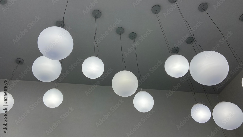 round electric chandeliers on a gray ceiling round electric chandeliers on a gray ceiling