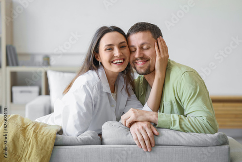 Happy young couple sitting ...