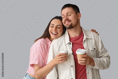 Happy young couple with cup...