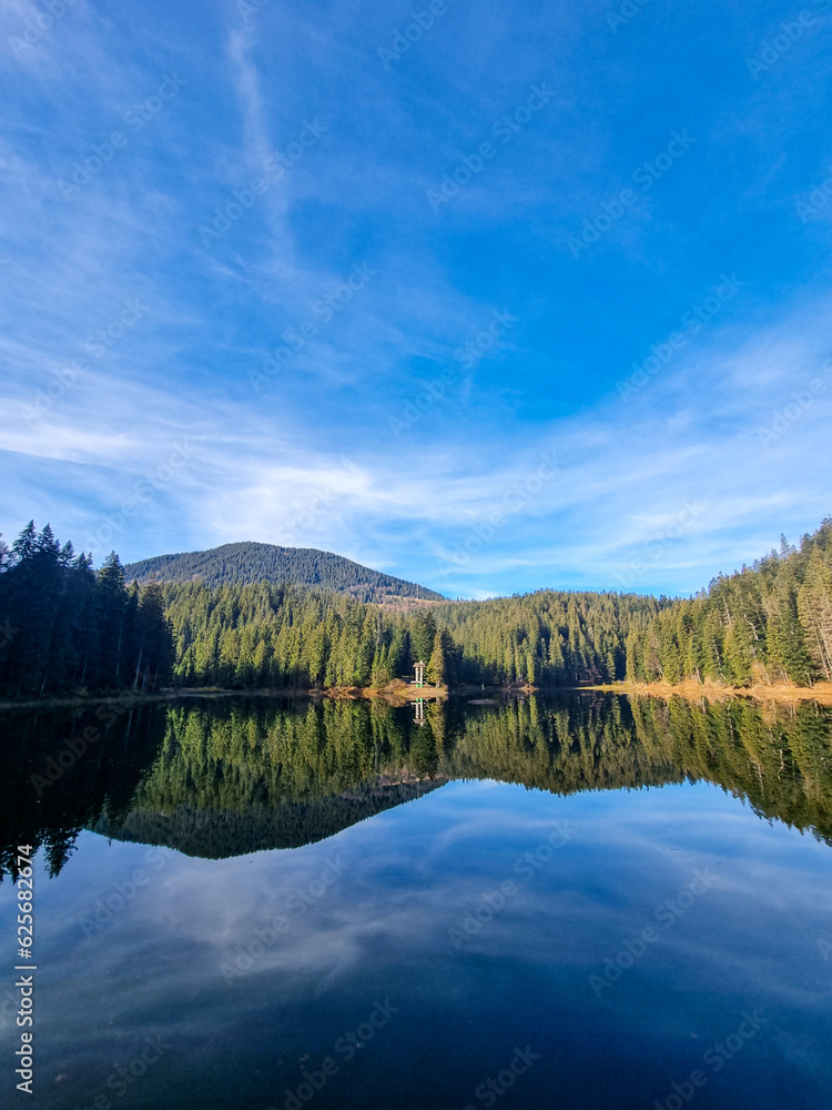 A panoramic view of a high mountain lake Synevir located in the Carpathian Mountains in Ukraine. 
