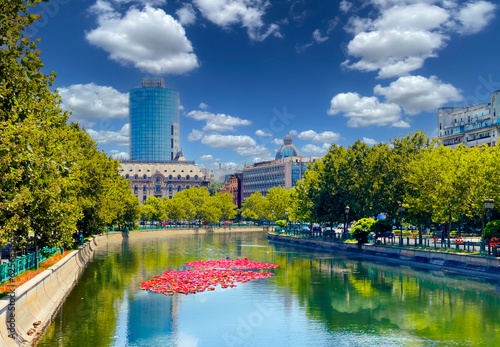 Landscape view of the famous Dambovita River crossing the city of Bucharest on a sunny day in Romania photo