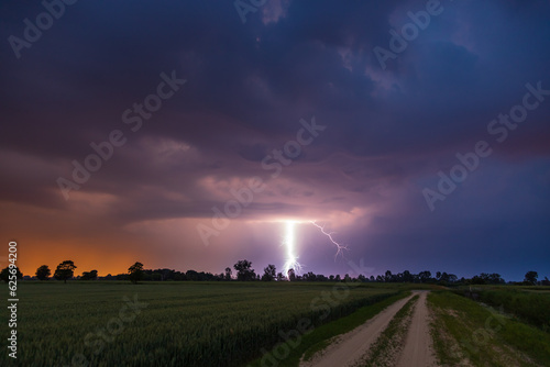 Storm over glade road in the middle of the fields. Stegna, Zulawy, Pomerania, Poland.