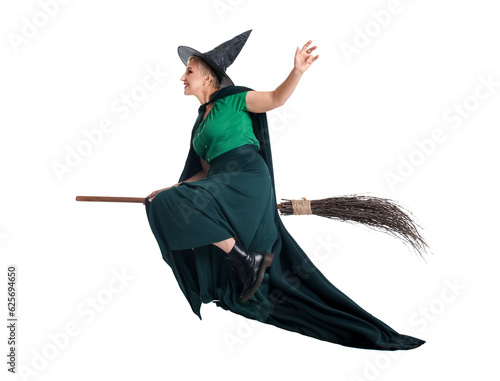 Mature witch with broom on ...