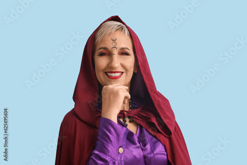 Mature witch on blue backgr...